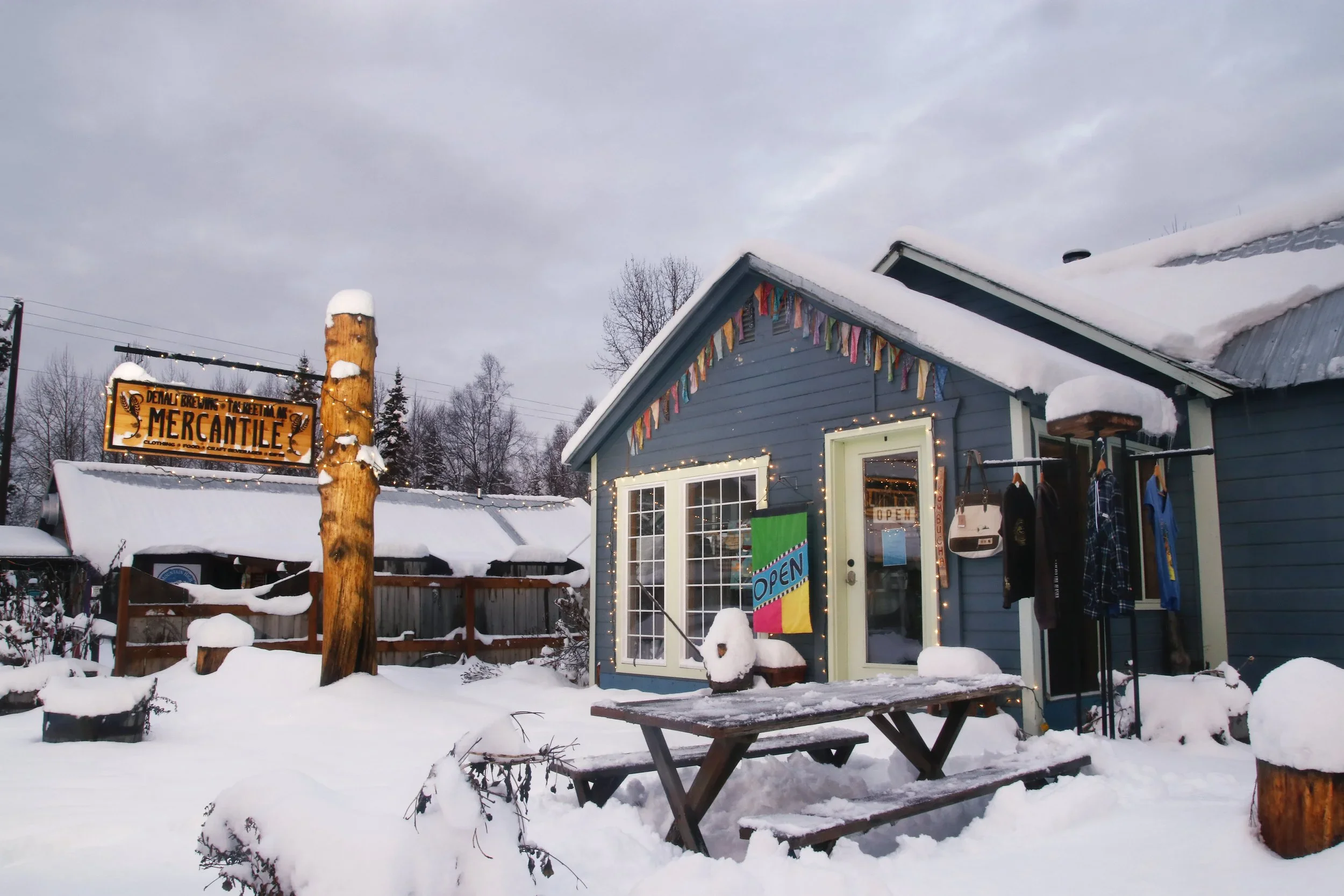 Denali Brewing outdoor winter scene with fire and patrons